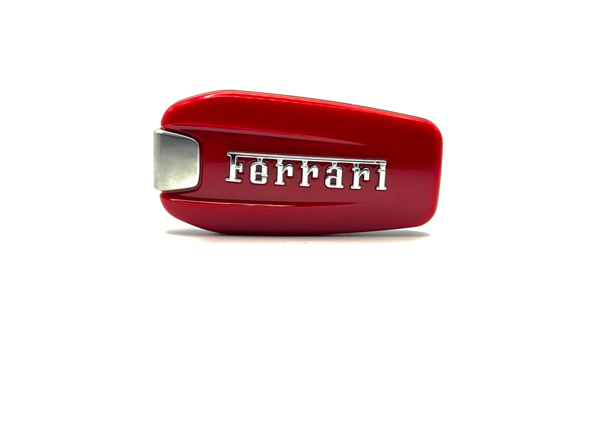 Red Ferrari key fob cover on a white background front on close up
